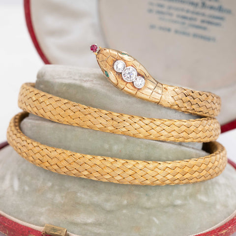 Antique triple-coil snake bracelet in gold with gem-set head