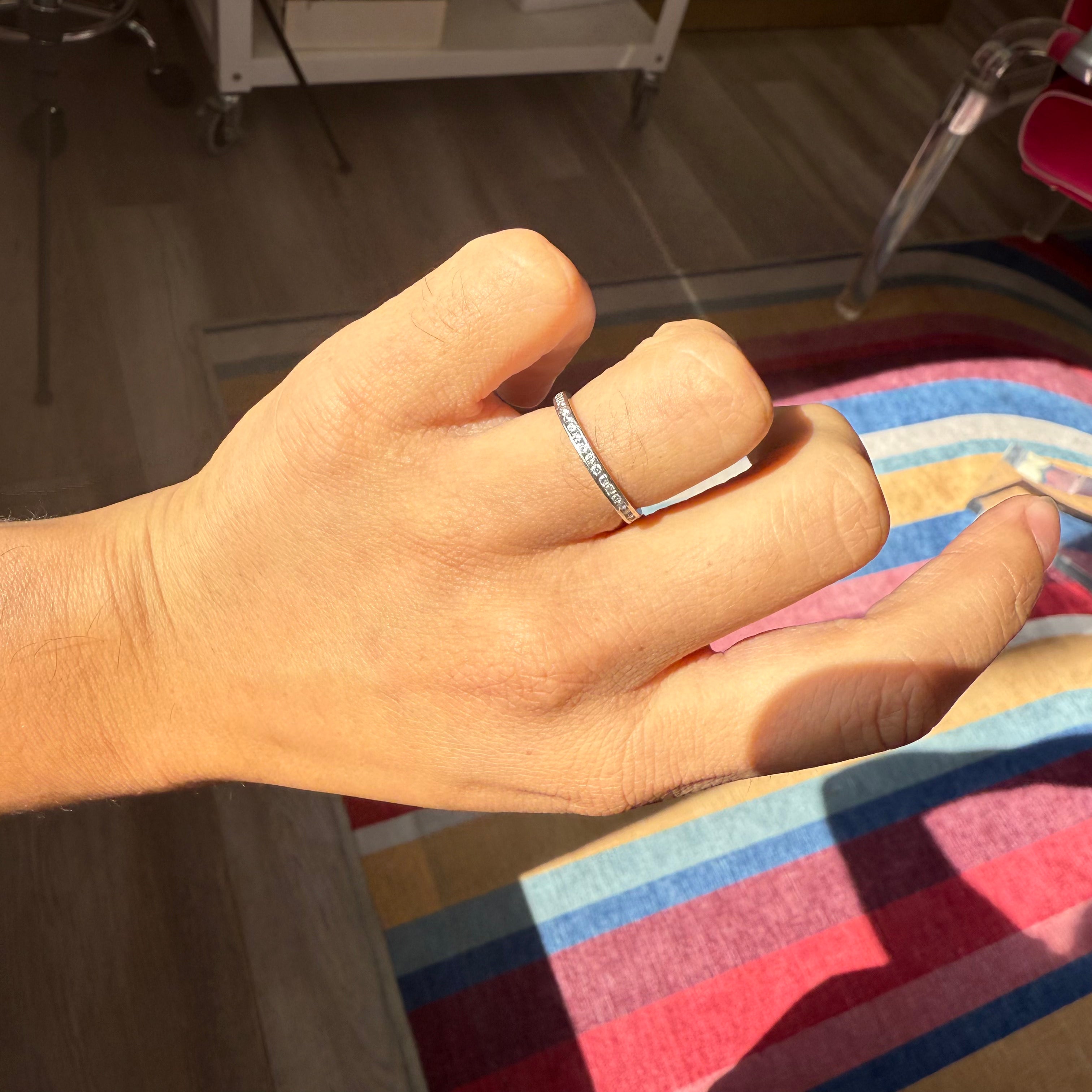 Tiffany & Co. vintage diamond eternity band in platinum shown on hand