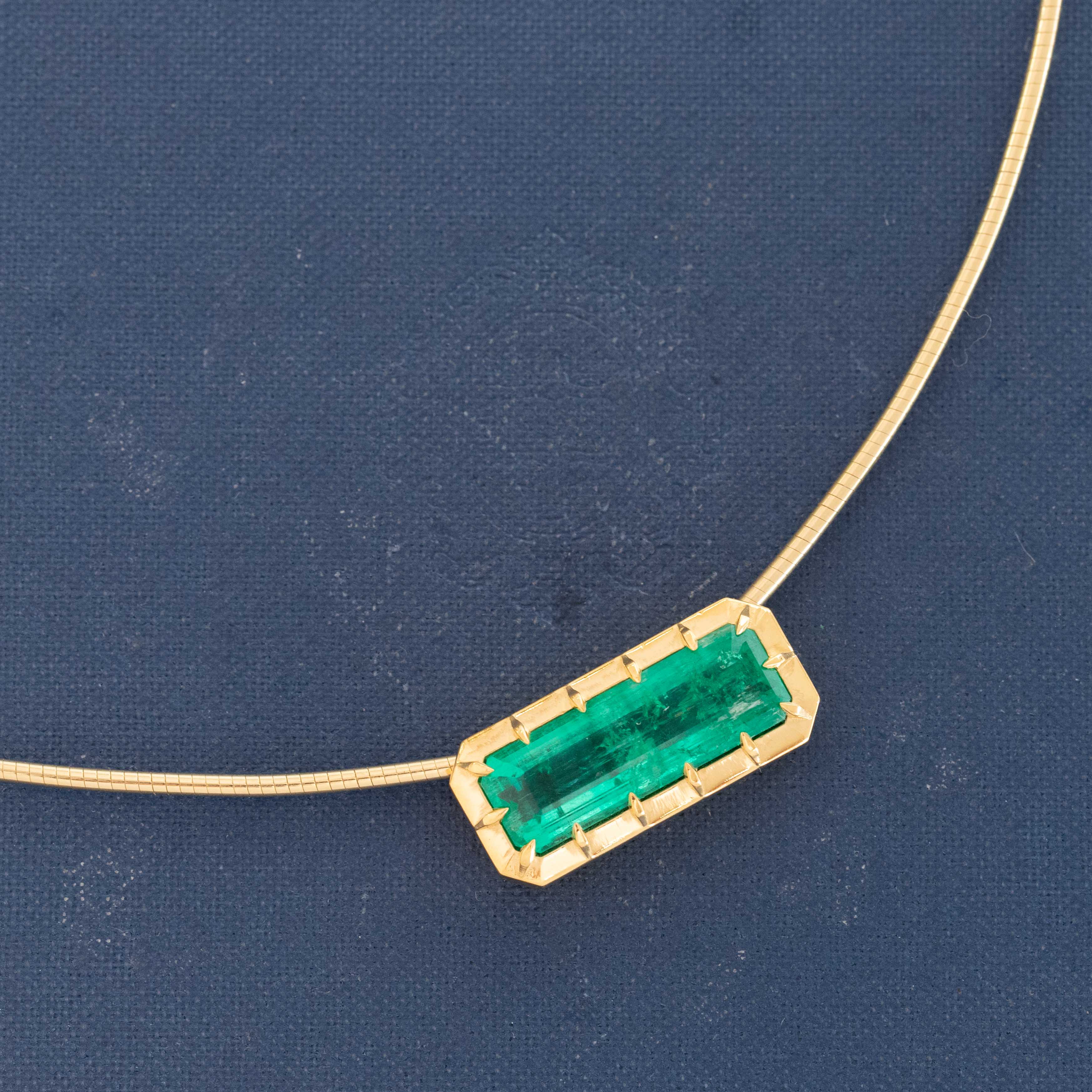 Modernist emerald necklace on gold snake collar