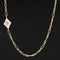 Kite-shaped diamond necklace set in 18k yellow gold bezel, stationed off-center on 14k Italian chain.