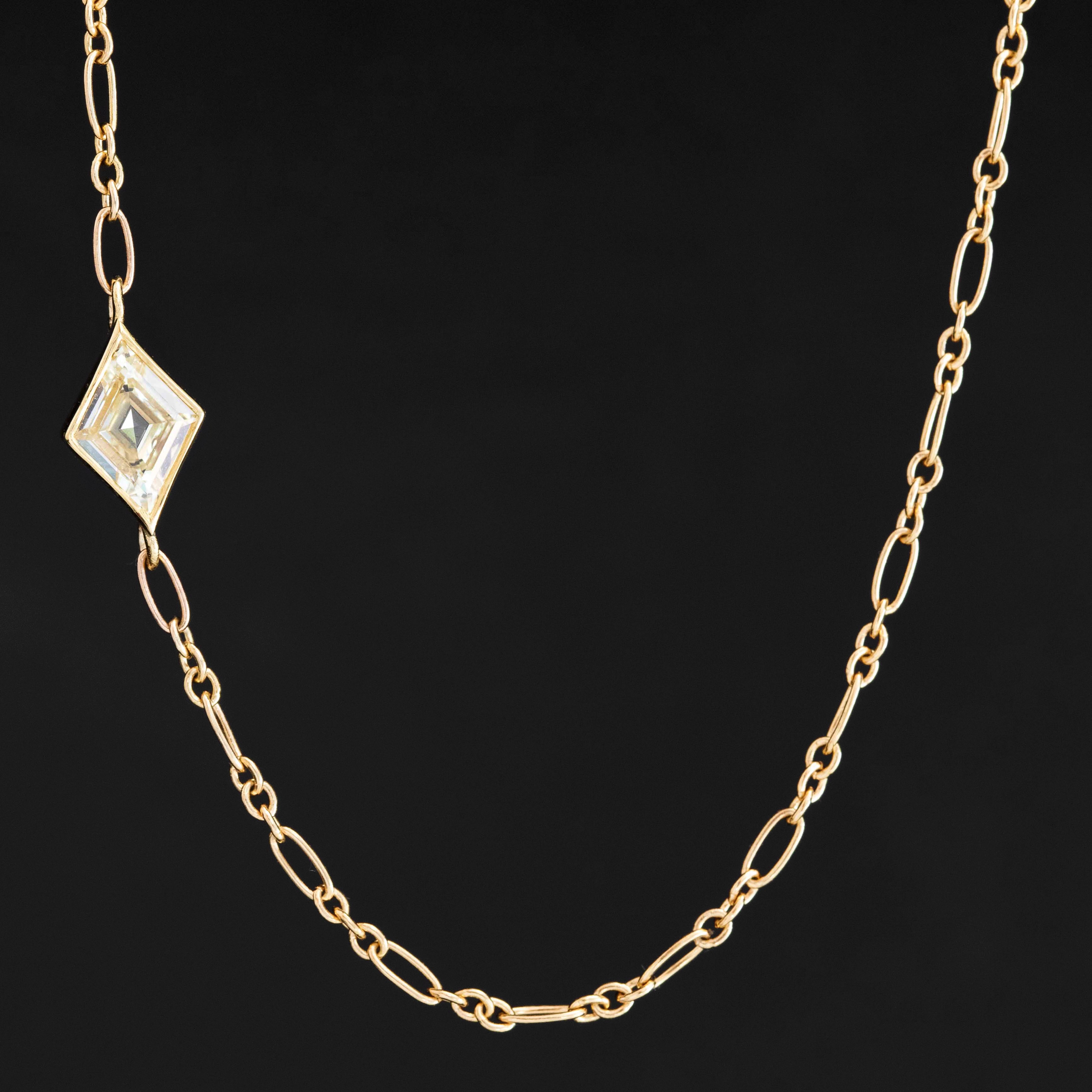 Kite-shaped diamond necklace set in 18k yellow gold bezel, stationed off-center on 14k Italian chain.