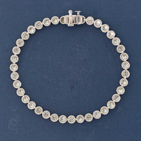 Detail of platinum bezels highlighting fiery diamond faceting and open culets