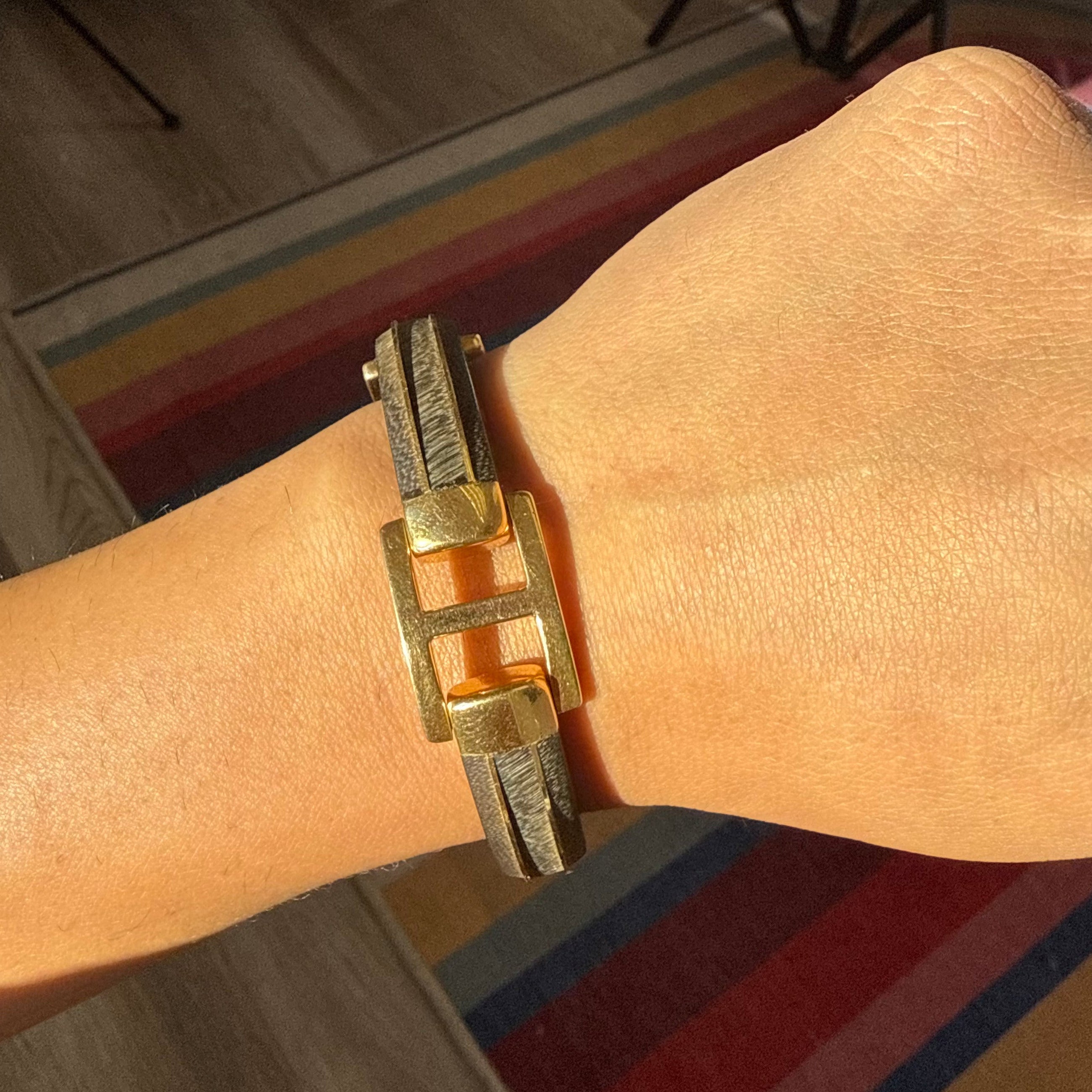 Close-up of Van Cleef gold and wood bracelet