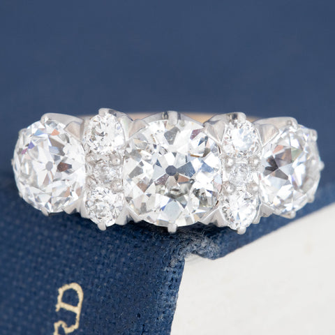 Antique Edwardian five-stone diamond ring with old mine cut diamonds in two-tone gold