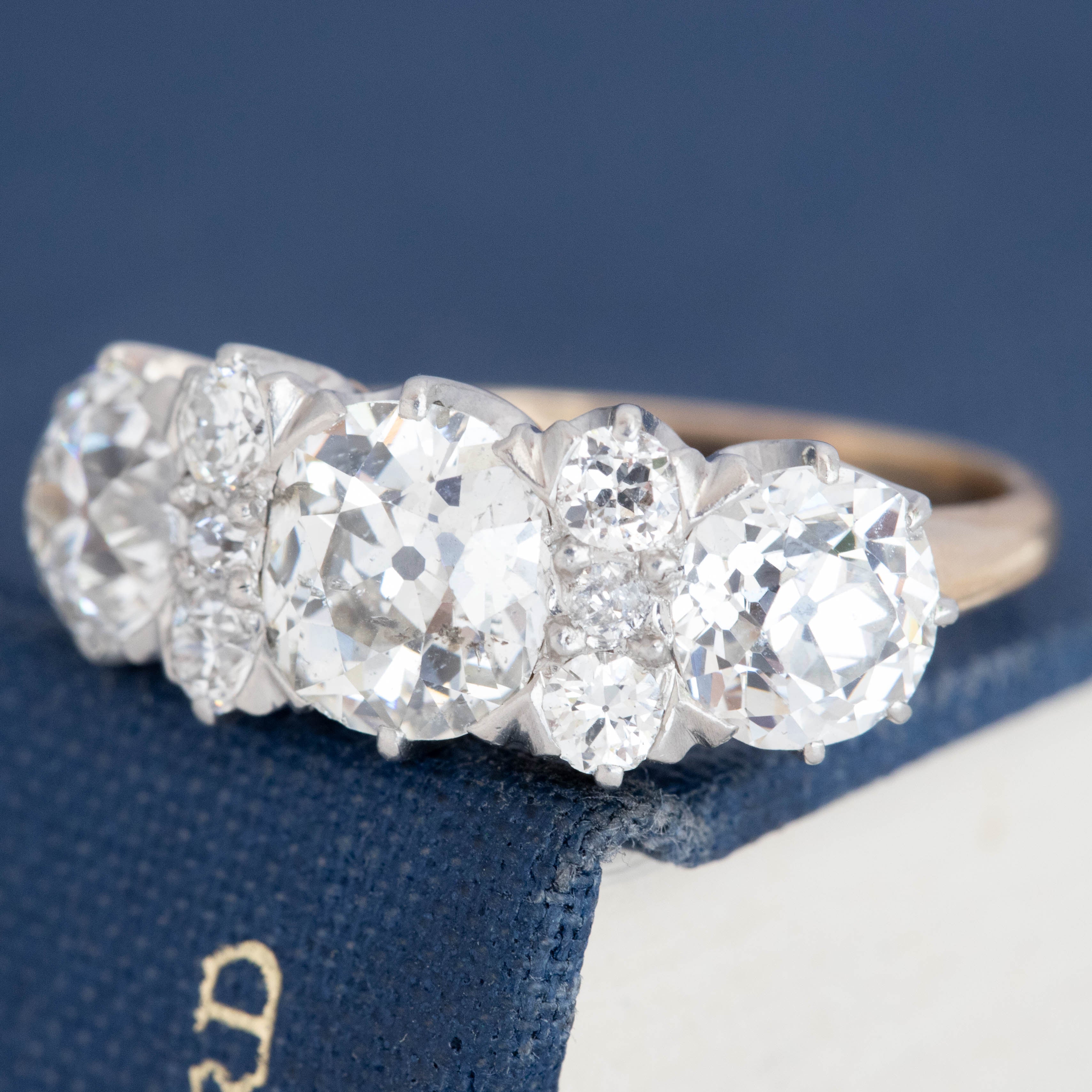 Edwardian diamond half-hoop ring with old European cut diamonds and crown-style gallery