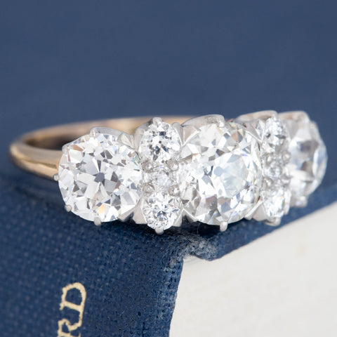 Antique five-stone diamond engagement ring with diamond spacers and claw prongs