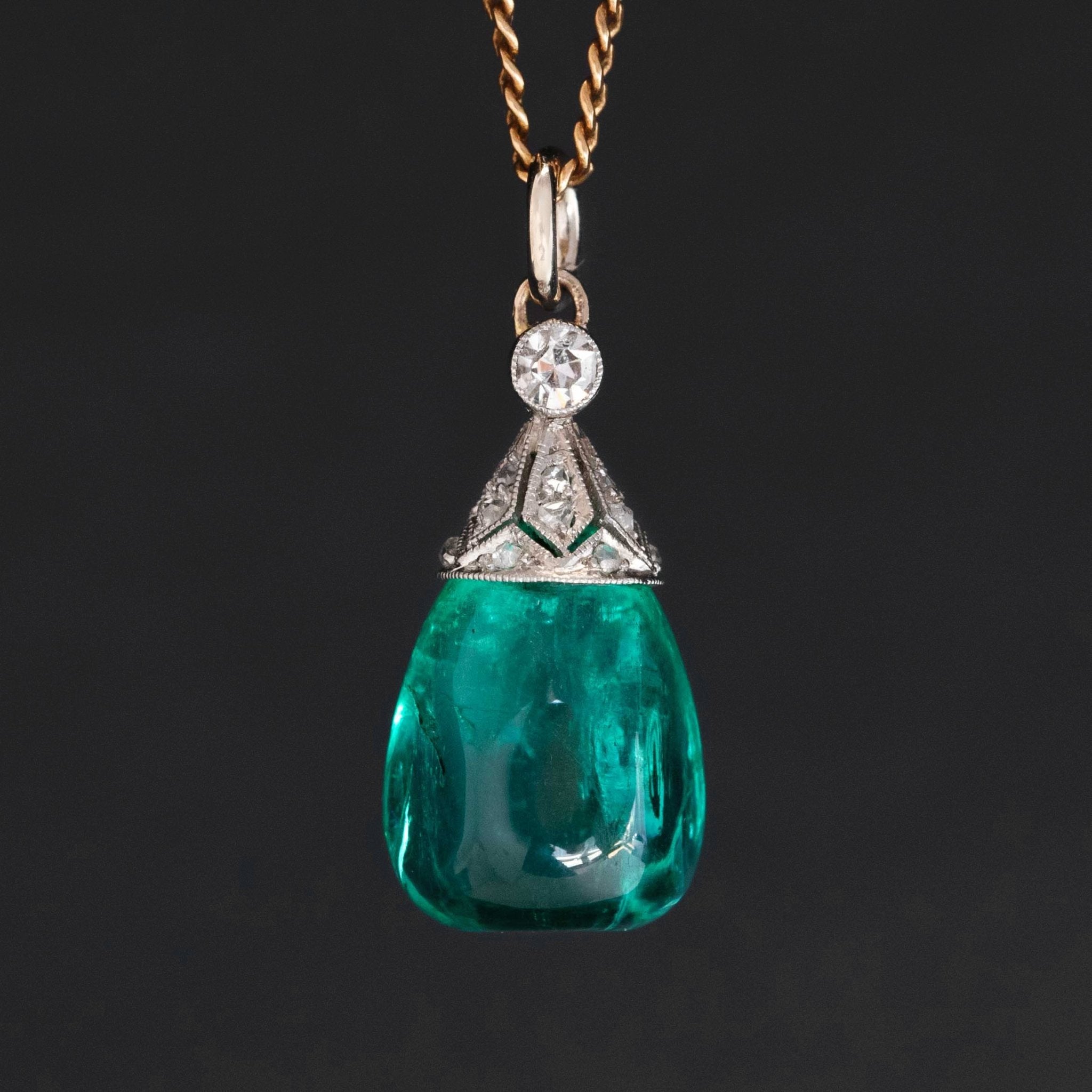 An antique Colombian emerald bead pendant with a beautiful, rich, and desirable color.  Strung on an antique component with diamonds.