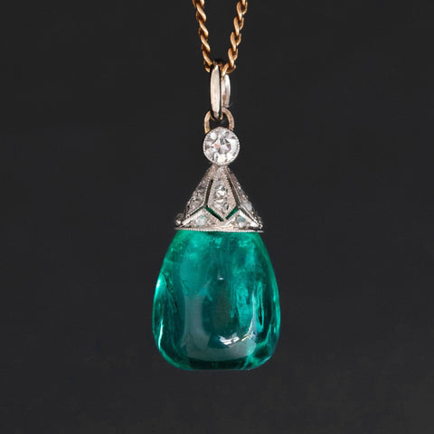 An antique Colombian emerald bead pendant with a beautiful, rich, and desirable color.  Strung on an antique component with diamonds.