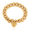 A chunky gold-tone Cuban link bracelet with a small heart-shaped padlock charm, displayed on a clean white background.