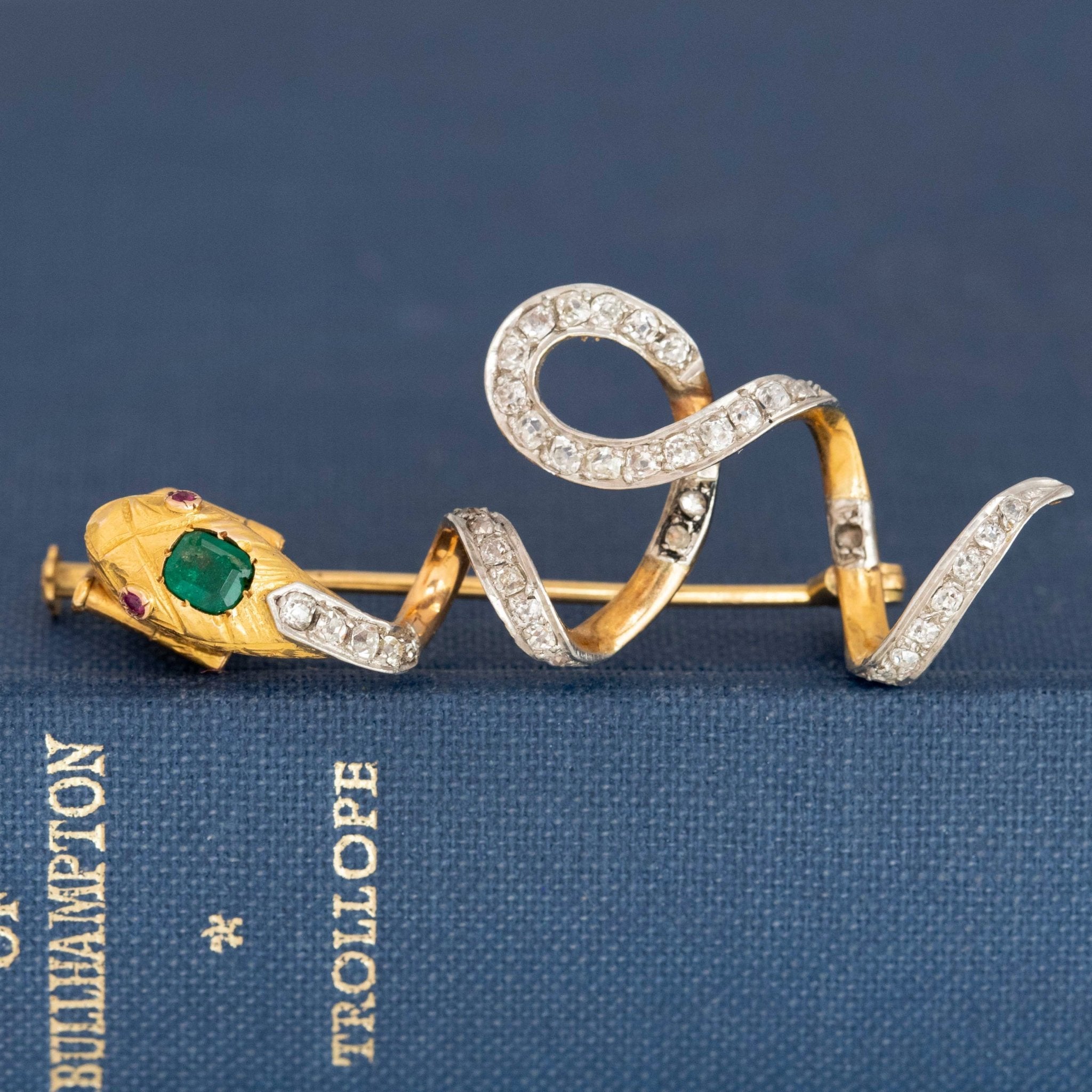 Antique serpent pin featuring old mine diamonds and engraved gold snake head