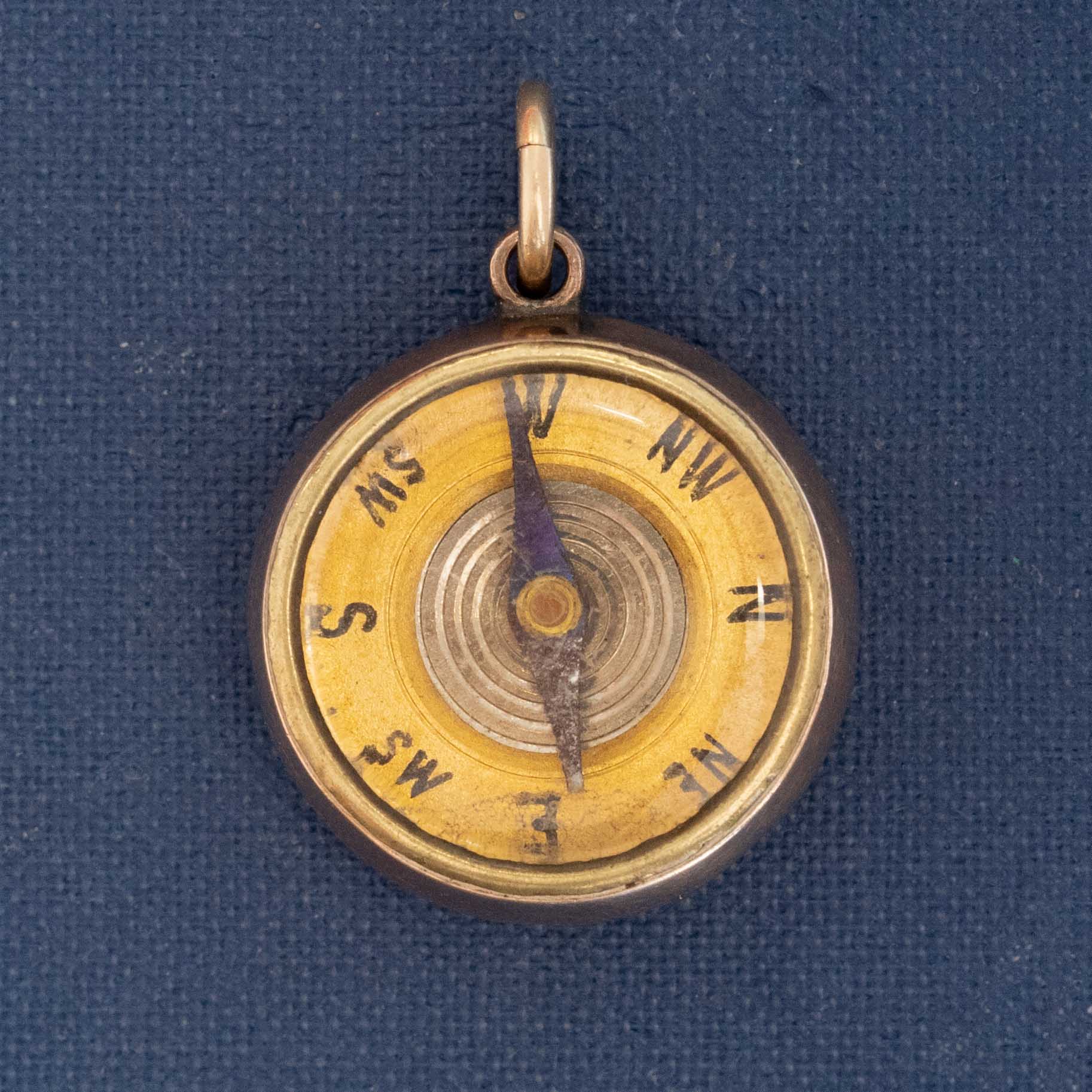 Antique compass pendant in 14k yellow gold with pink agate back