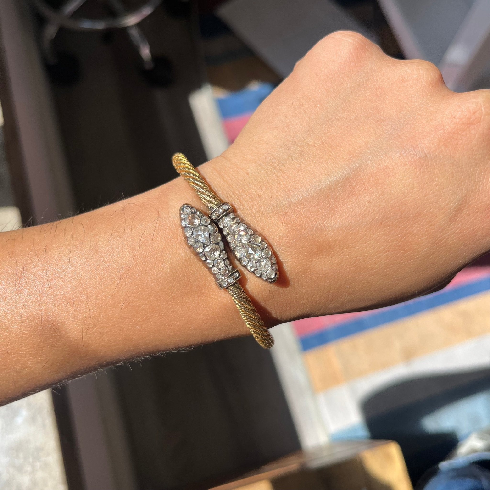 Victorian antique snake bracelet in twisted gold, featuring rose-cut diamond accents on serpent head terminals.