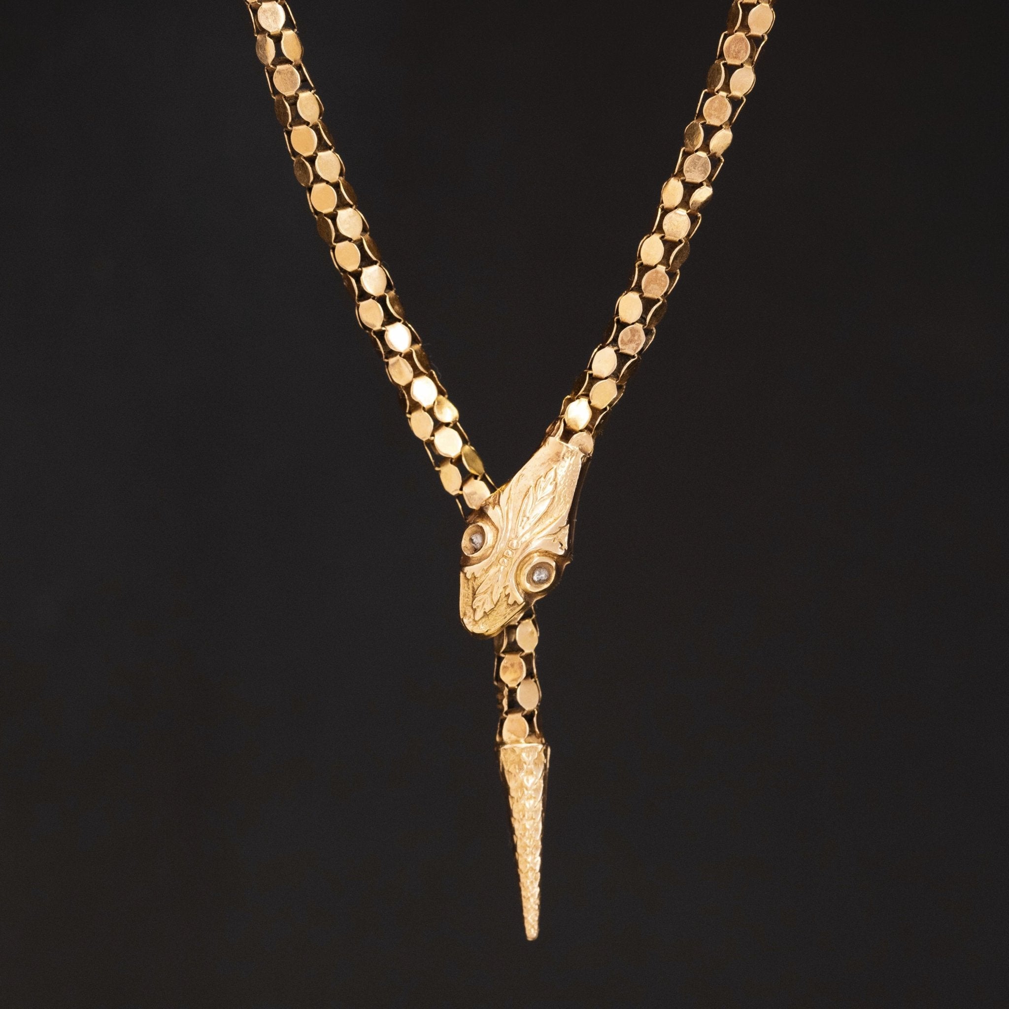 Close-up of antique serpent necklace in yellow gold