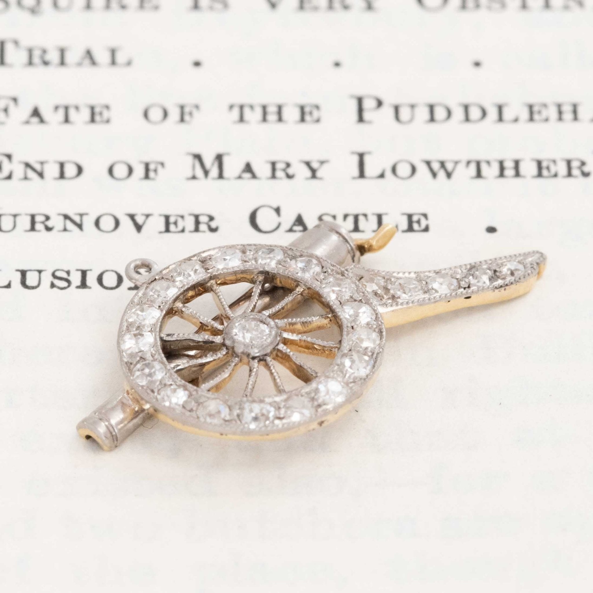 Converted brooch cannon charm with diamond wheel