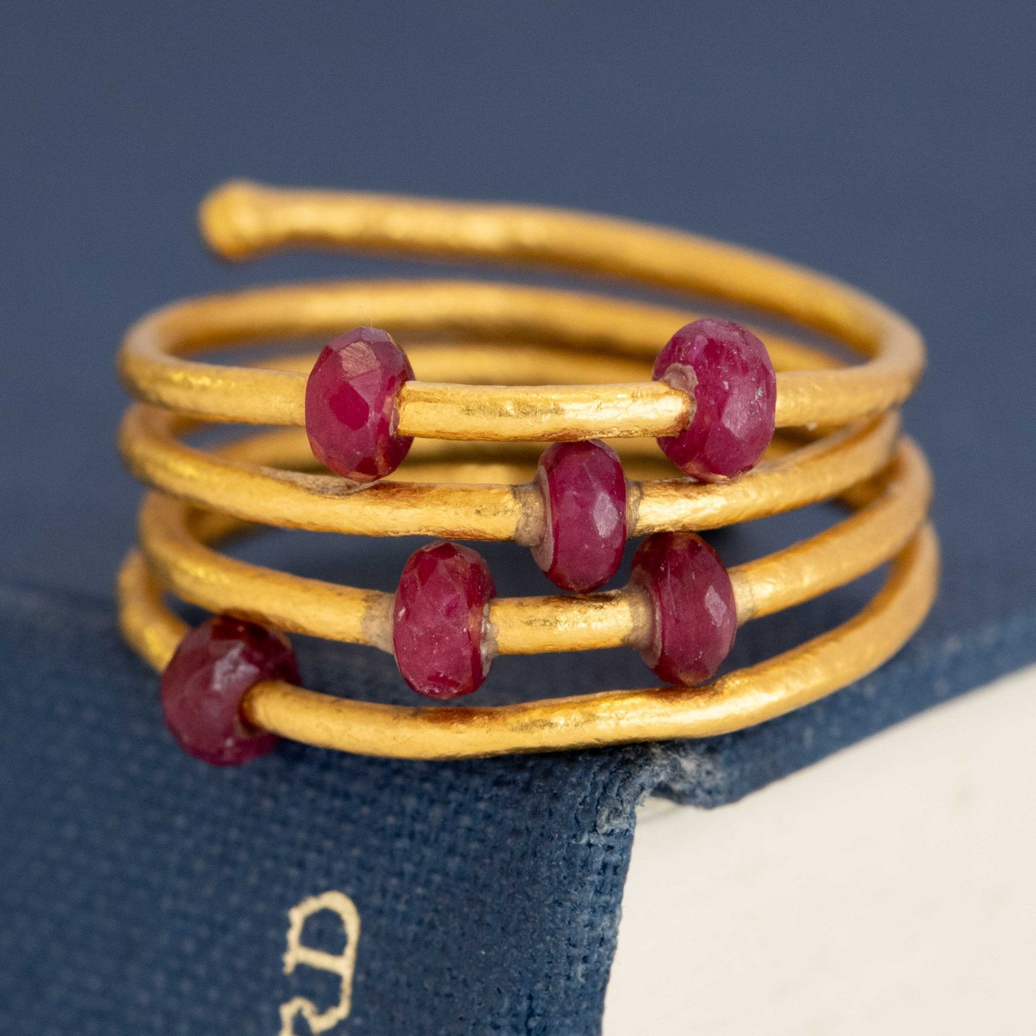 Gurhan 24k yellow gold ruby coil ring with faceted ruby beads – handcrafted luxury designer jewelry