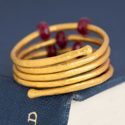 Designer ruby ring in 24k yellow gold by Gurhan – unique coiled band with gemstone details