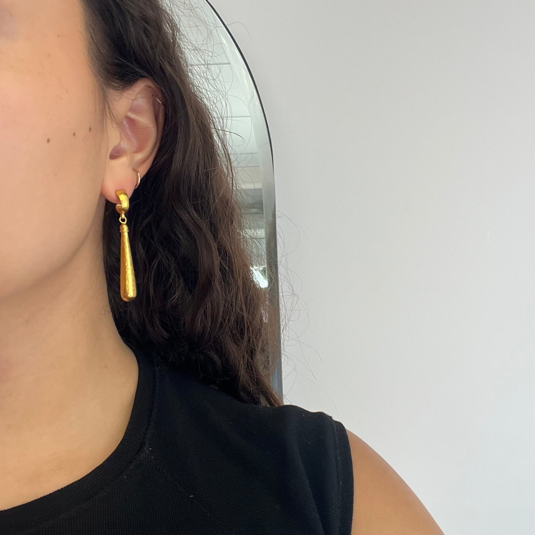 ear shot of handcrafted Istanbul-made Gurhan drop earrings in rich 23kt gold