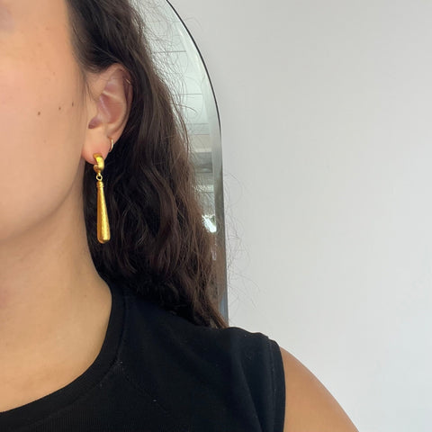 ear shot of handcrafted Istanbul-made Gurhan drop earrings in rich 23kt gold