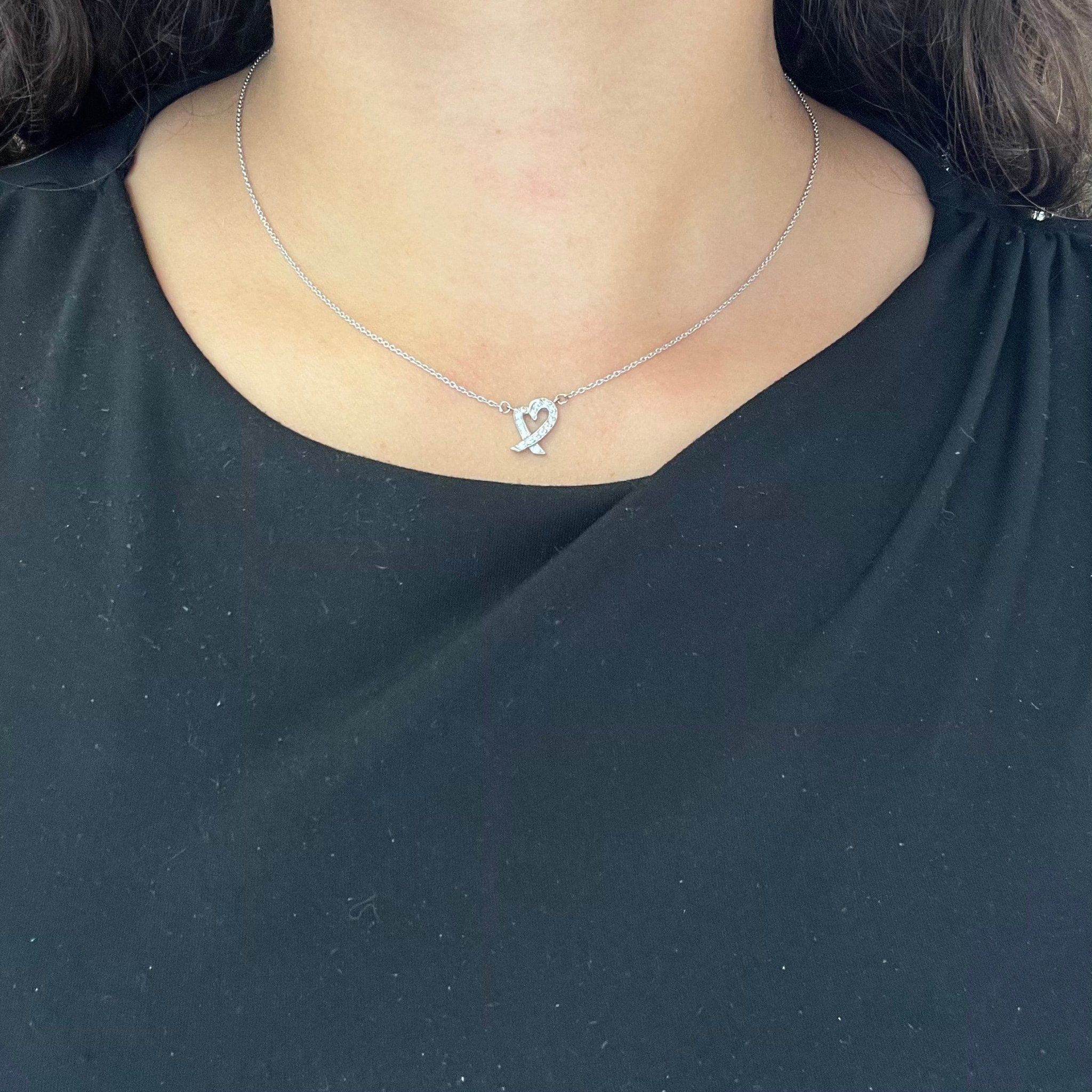 Neck shot of Tiffany & Co. platinum diamond Loving Heart necklace by Paloma Picasso