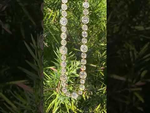 Video showing a riviere with bezel set old European cut diamonds in varying sizes in yellow gold.  The differing sizes give the piece a more contemporary feel yet so unique in that the diamonds are all vintage diamonds.  The video shows the immense sparkle from these antique diamonds.