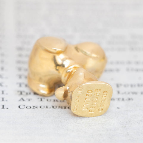 RARE collectible Vintage Gold Snoopy Pendant by Cartier shown sideways to display Cartier stamps