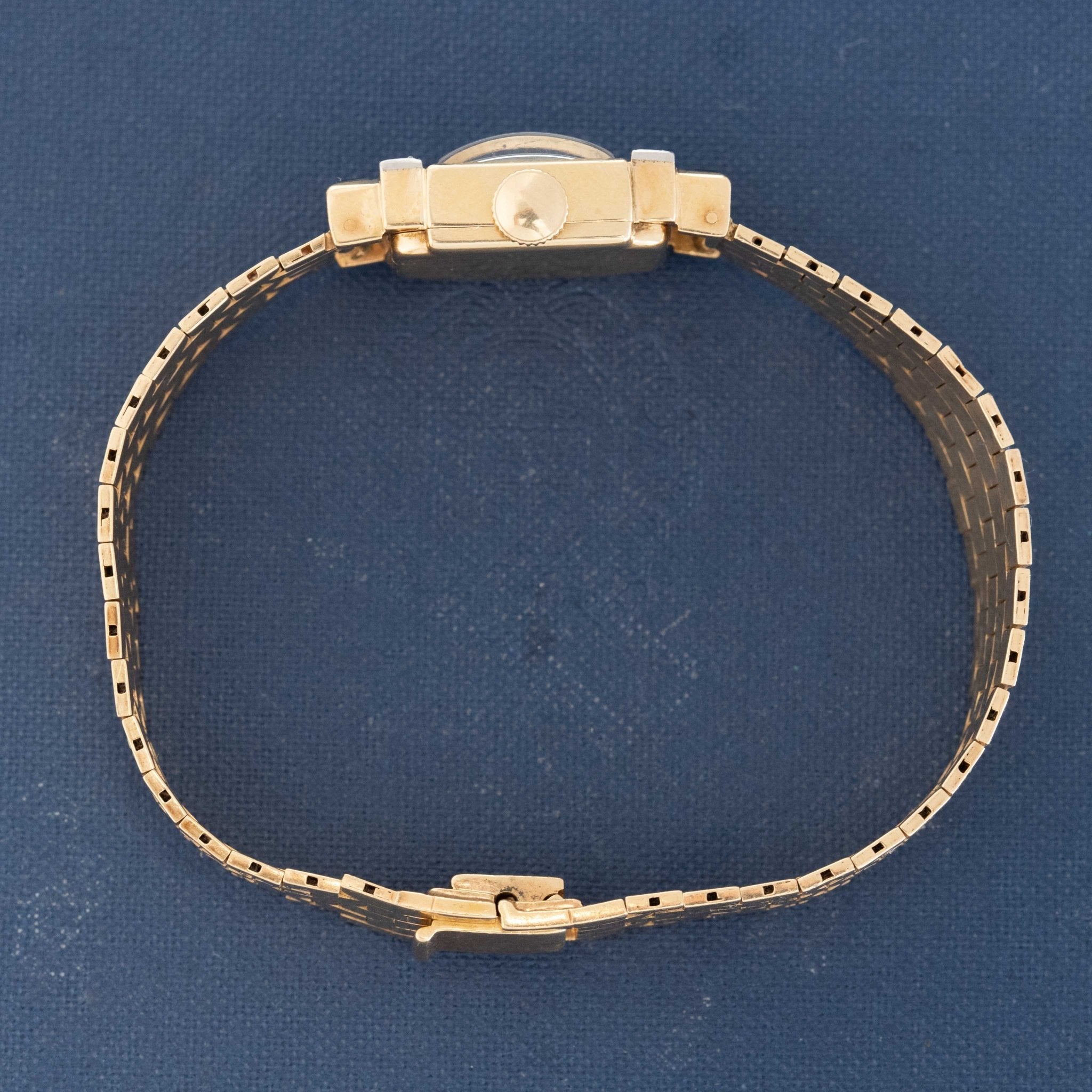 Square-dial Tiffany watch in 14k gold on blue book