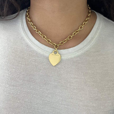 Chunky, beautifully crafted gold links come together with a jumbo lobster clasp by Tiffany and Co, and suspended from the center is a blank heart-shaped gold tag. We love how bold and chic this one is on the neck - it is everything you want a good gold chain to be. 16" in length