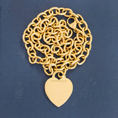 Chunky, beautifully crafted gold links come together with a jumbo lobster clasp by Tiffany and Co, and suspended from the center is a blank heart-shaped gold tag. We love how bold and chic this one is on the neck - it is everything you want a good gold chain to be. 16" in length