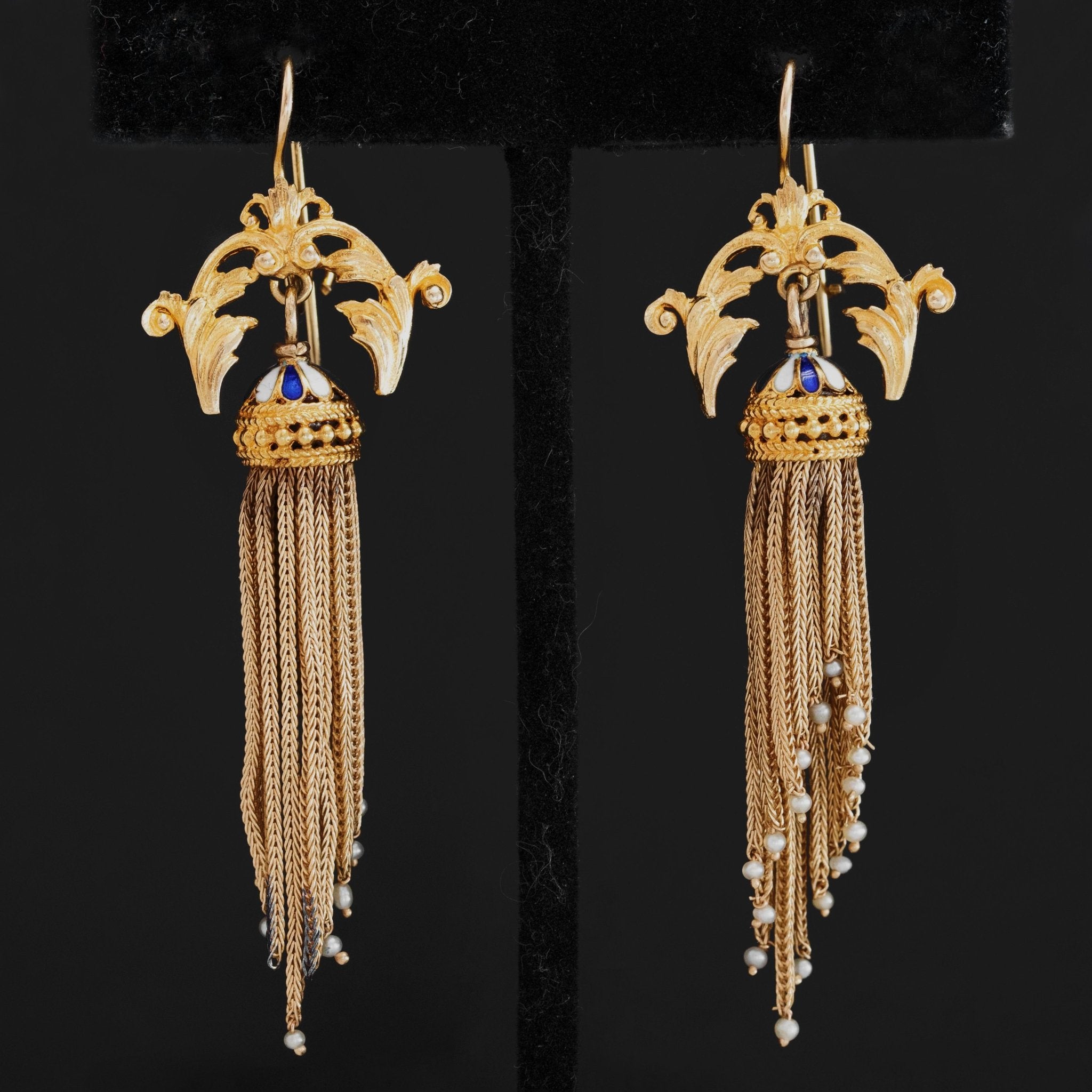 Antique Victorian gold tassel earrings with blue enamel and pearl details on black background