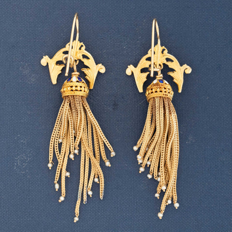Close-up of ornate 15k gold Victorian earrings with enamel dome and seed pearl tassels