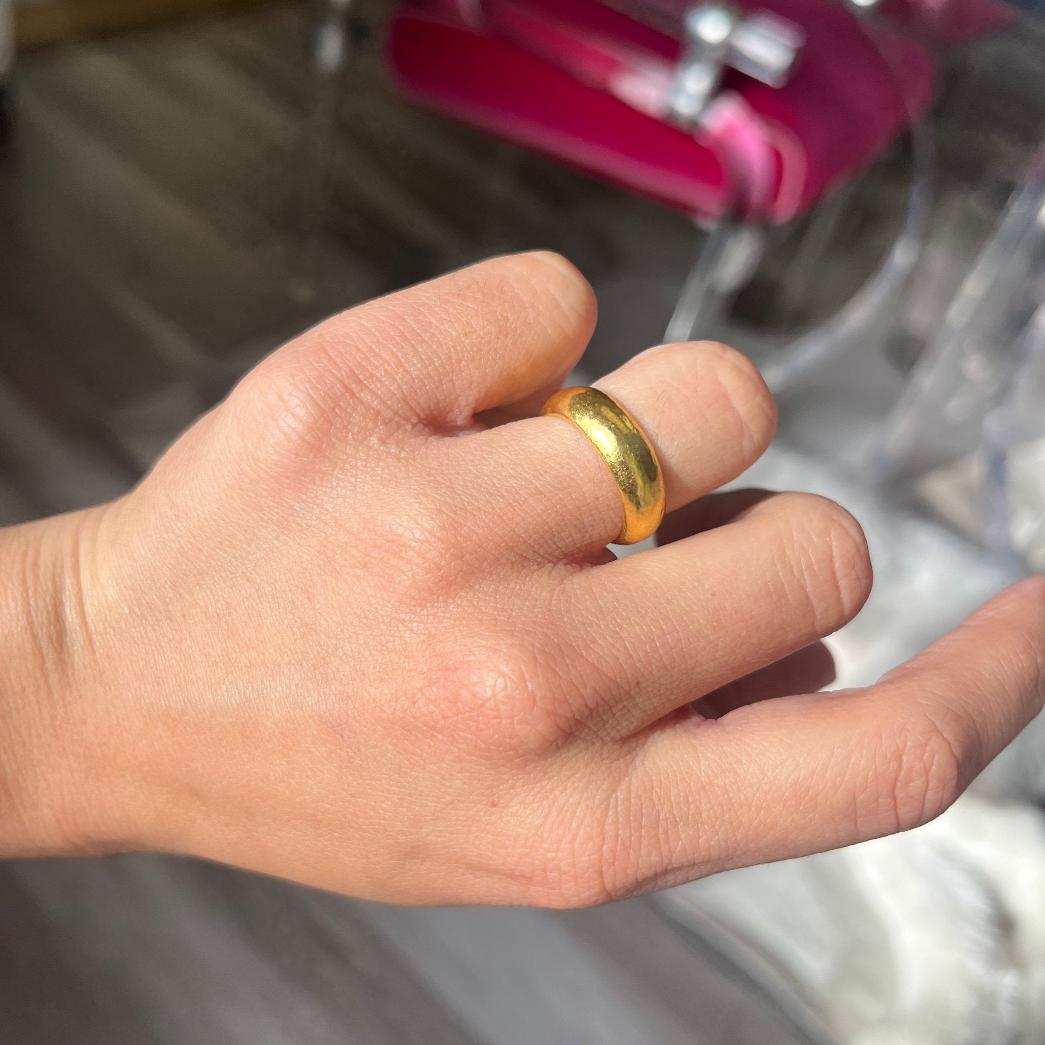 vintage 24kt wide gold wedding band on finger