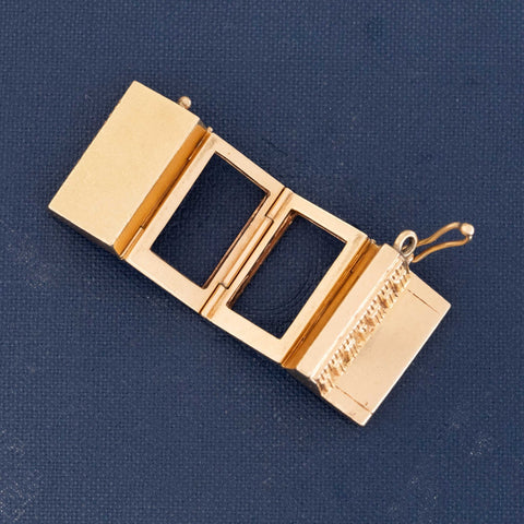 14k gold accordion pendant locket with multiple photo slots and miniature engraved keys.