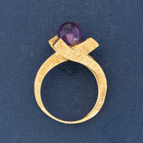 1960s–70s sculptural gold ring with amethyst cabochon bead