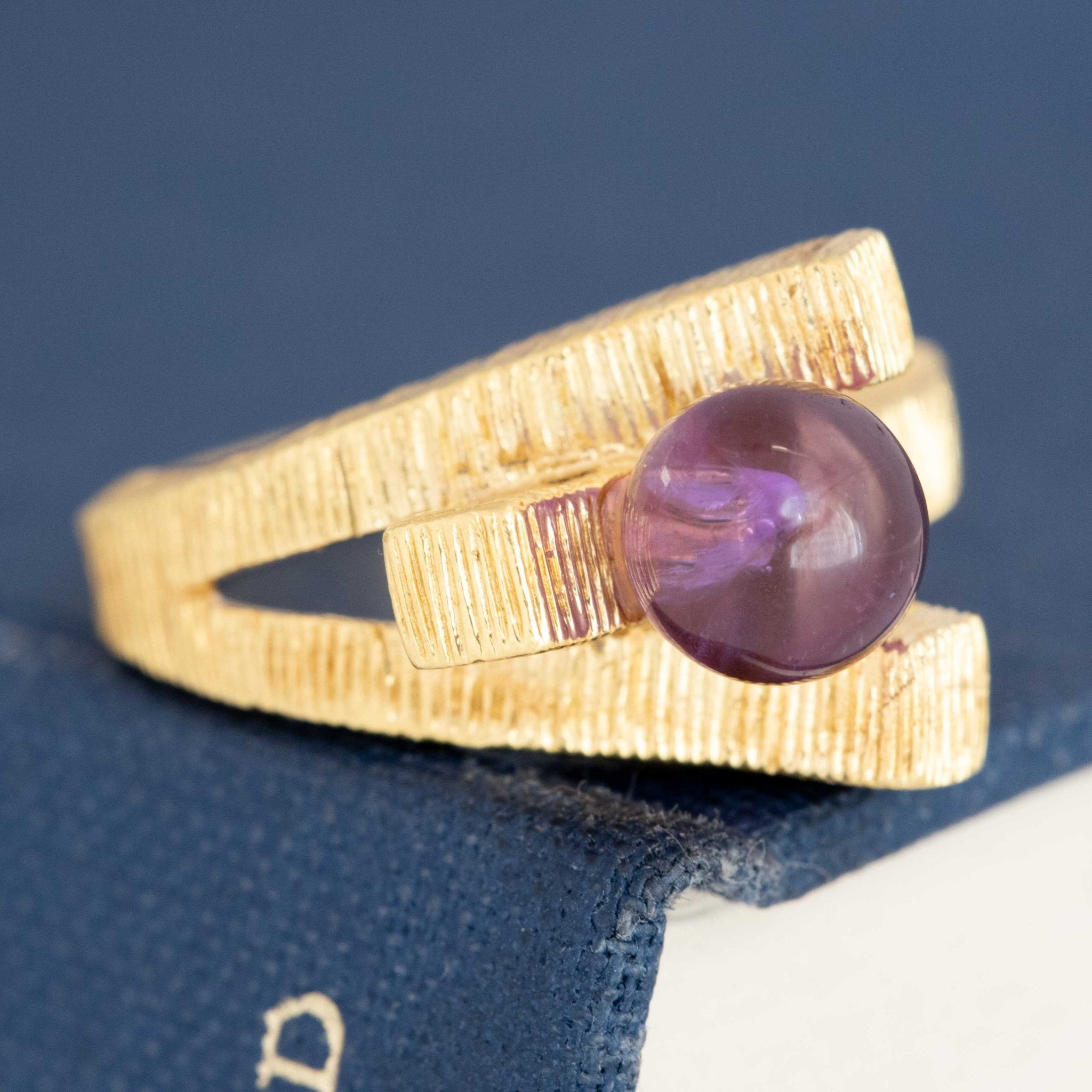 Textured yellow gold modernist ring with purple amethyst