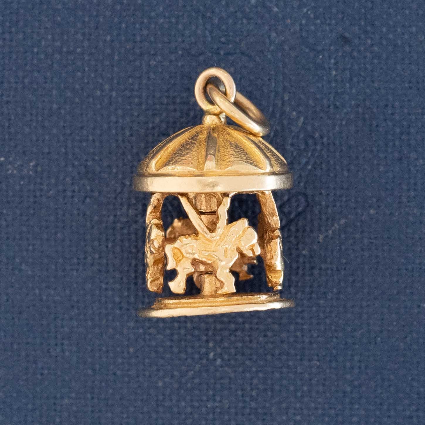 14k gold articulating carousel pendant charm with moving design.