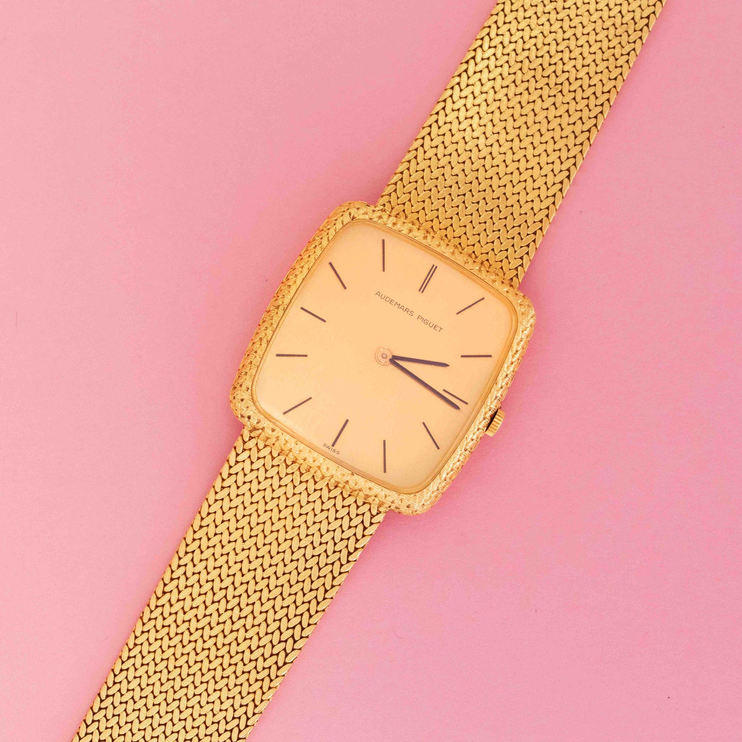 Vintage Audemars Piguet mesh dress watch in 18kt yellow gold on pink background