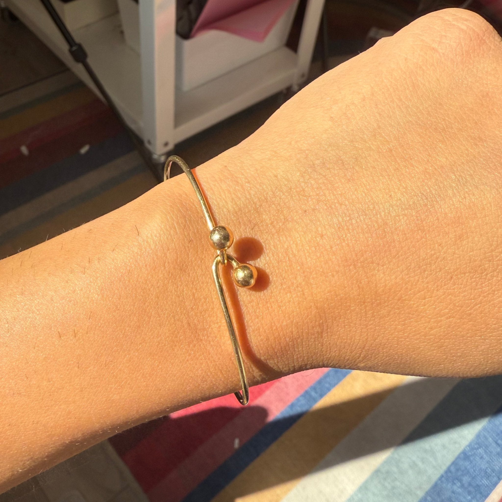 Classic 14K gold bypass bracelet with ball finials