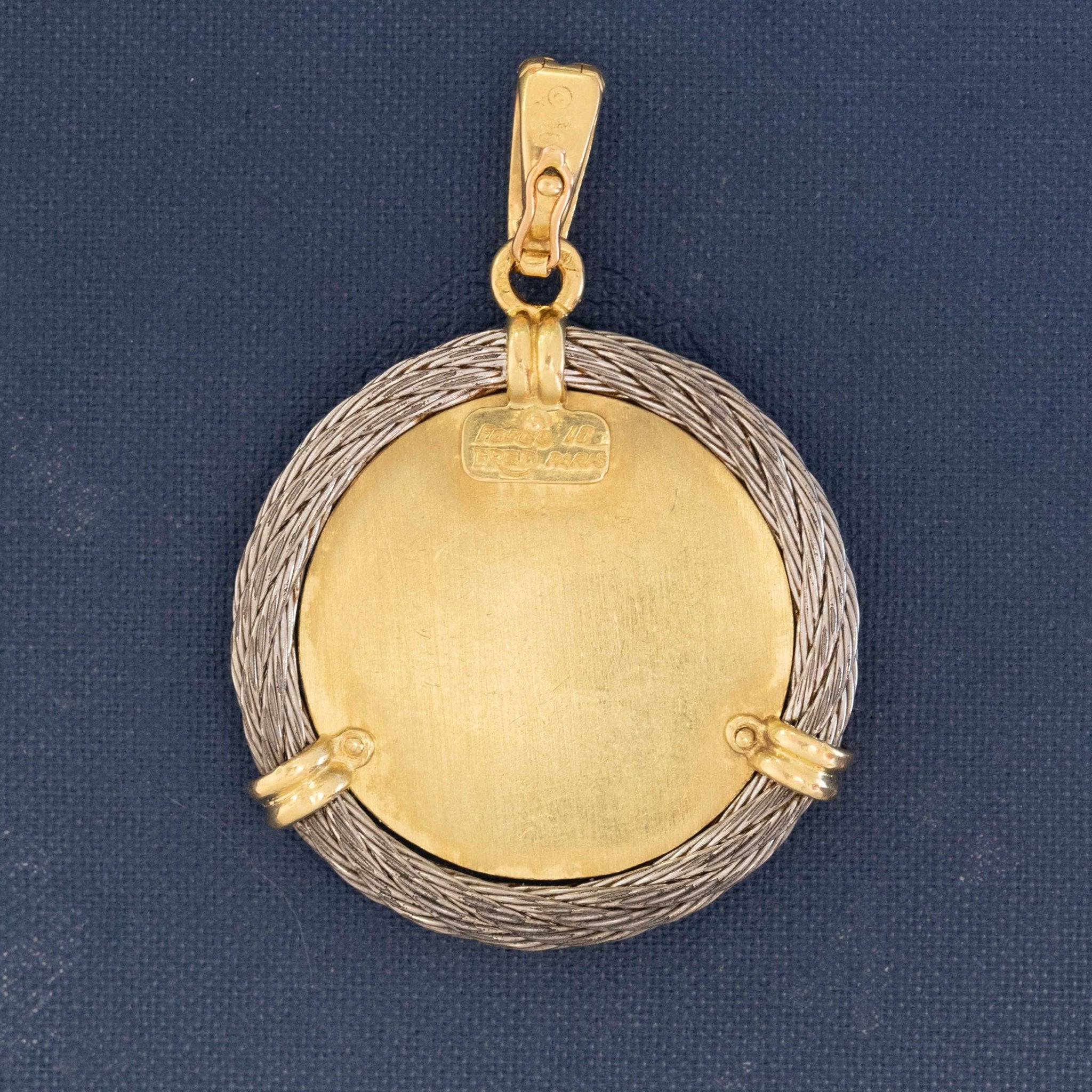 Close-up of vintage Cancer zodiac pendant by Fred Paris, featuring crab motif in gold with three diamonds and twisted rope frame.

Collectible vintage Fred Paris Cancer zodiac medallion, 18K yellow gold with diamond details and signed hallmark.