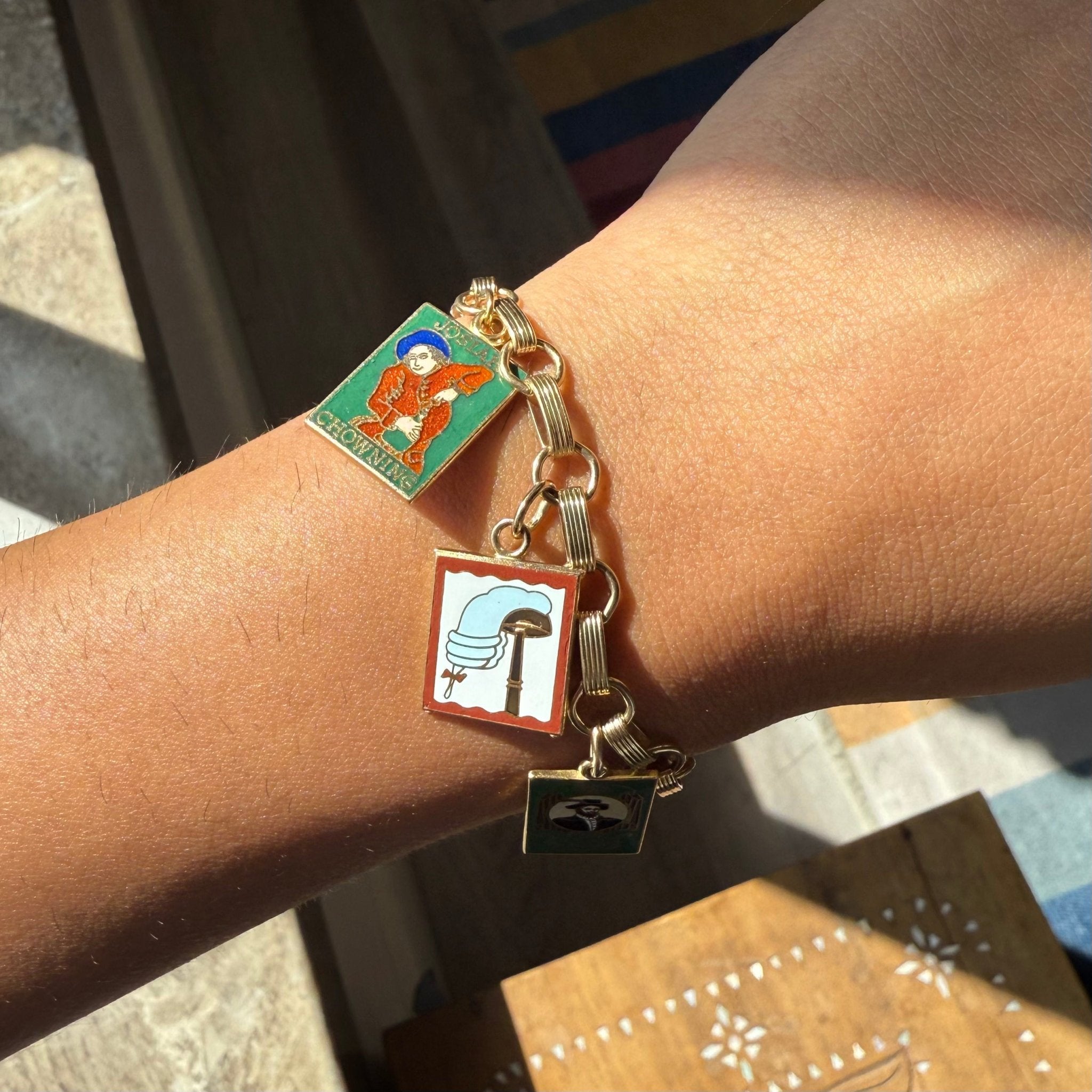 Antique charm bracelet, enamel depictions of colonial scenes on wrist