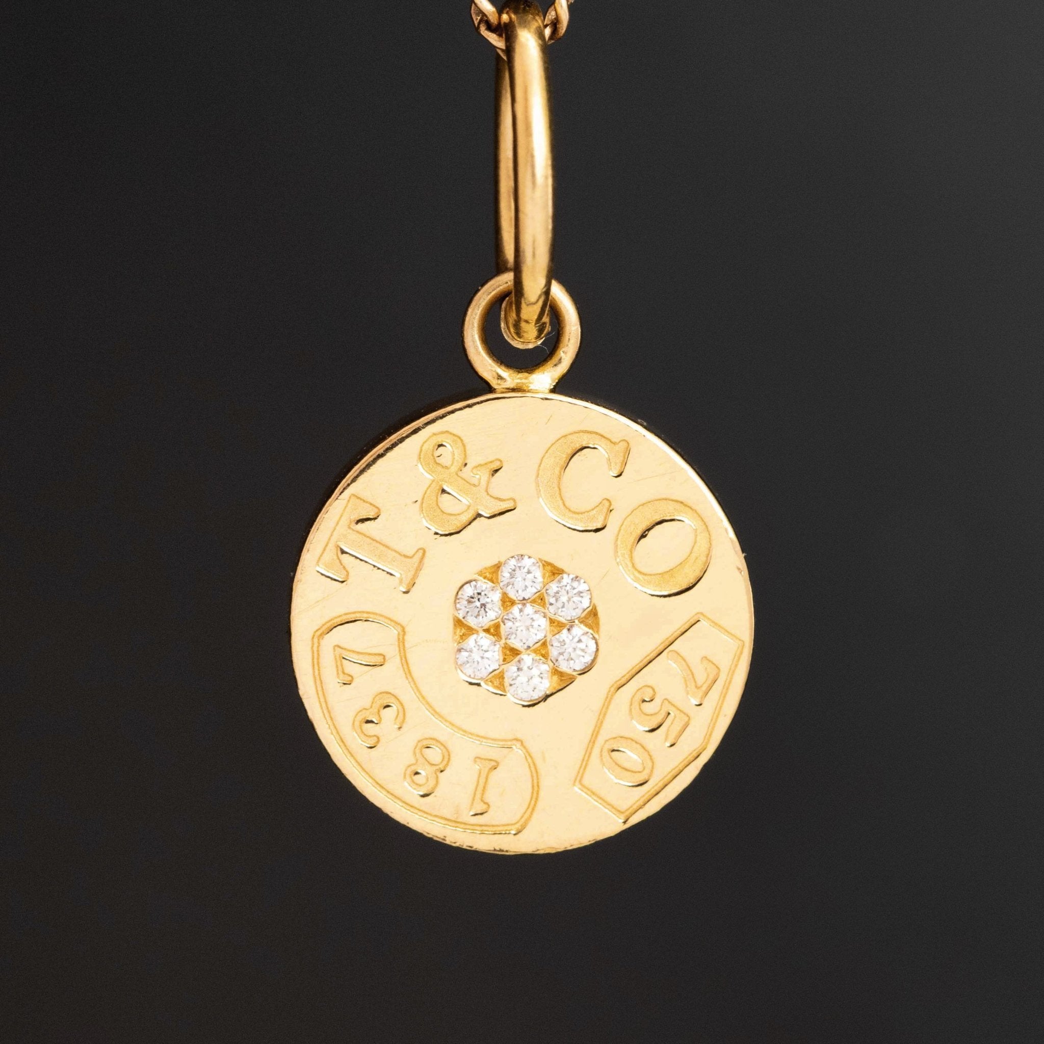 Vintage Tiffany &amp; Co. 1837 round medallion charm pendant in 18k yellow gold with diamond cluster.