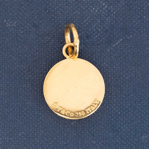 Close-up of Tiffany &amp; Co. yellow gold charm pendant stamped 1837 with diamond accents.