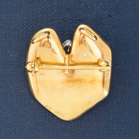 Tiffany-style frog brooch in 18k gold and platinum on blue background