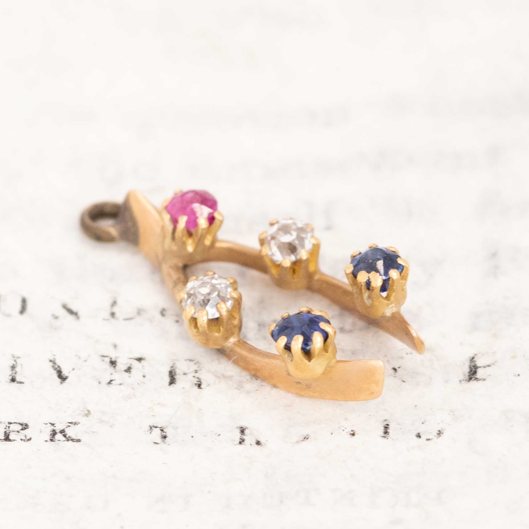 Mini yellow gold wishbone pendant with colorful gemstones