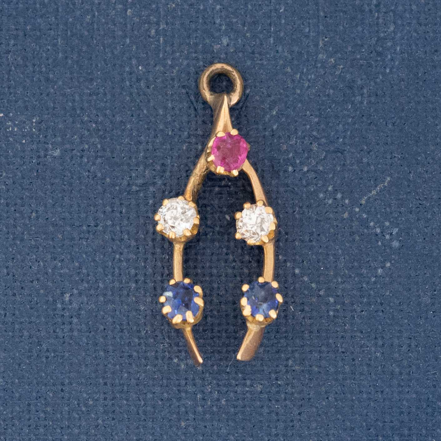 Vintage wishbone charm with ruby, diamond, and sapphire gemstones