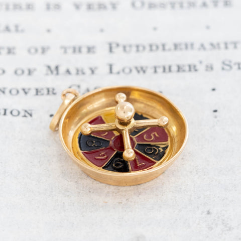 Gold roulette wheel charm inspired by French casino jewelry