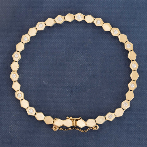 Yellow gold hexagon link bracelet with flush-set round diamonds, 15.5 grams.