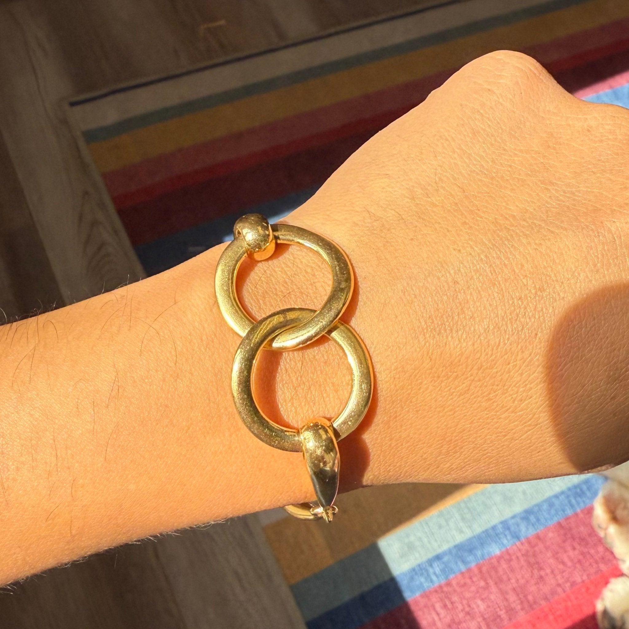 vintage gold horsebit bracelet on wrist, large circular links