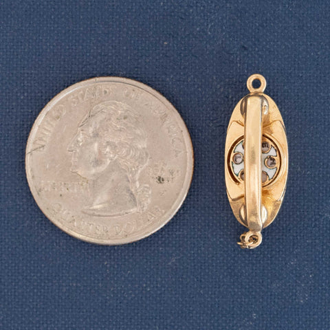 Close-up of vintage 14kt gold telephone charm with engraved dial