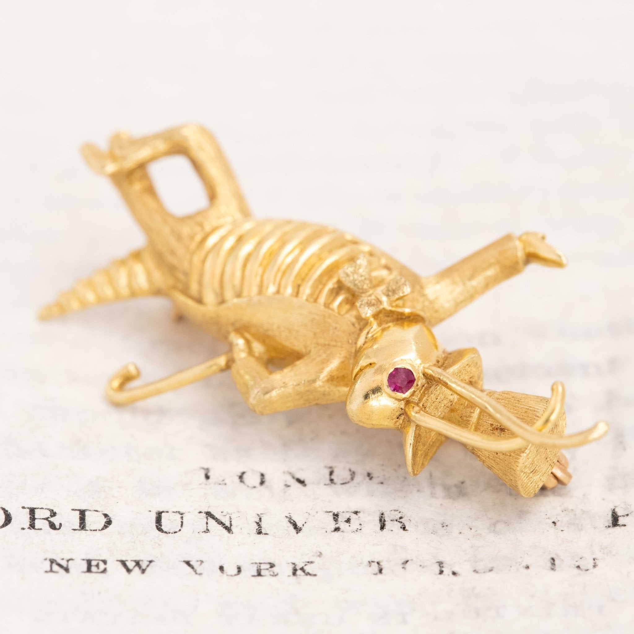 Vintage 18K gold Jiminy Cricket brooch with ruby eye