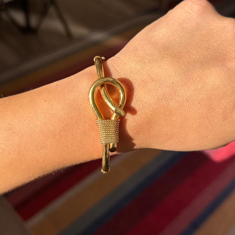 Vintage gold knot bangle bracelet on wrist